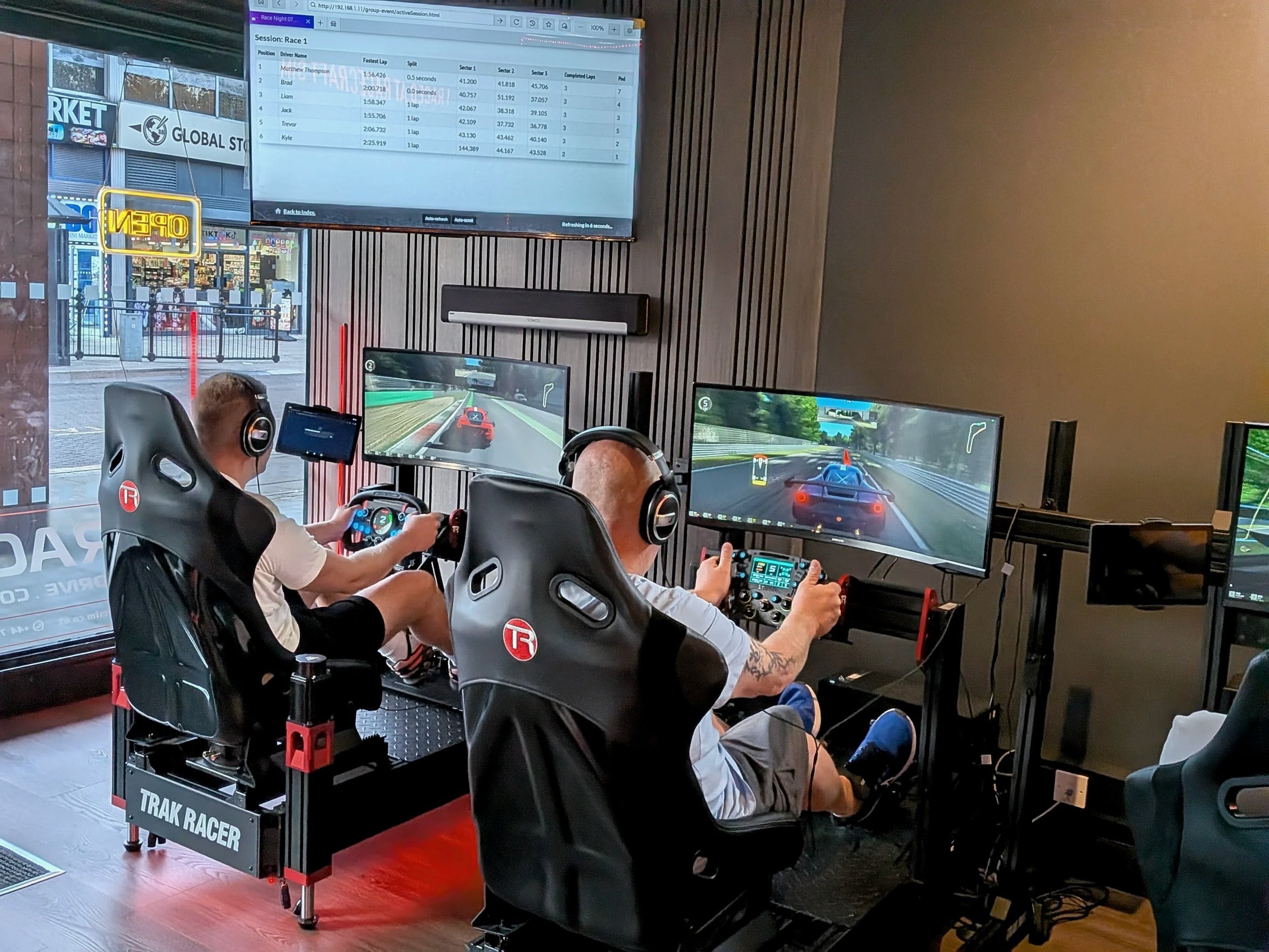 Drivers racing on ultrawide displays with live timing overhead